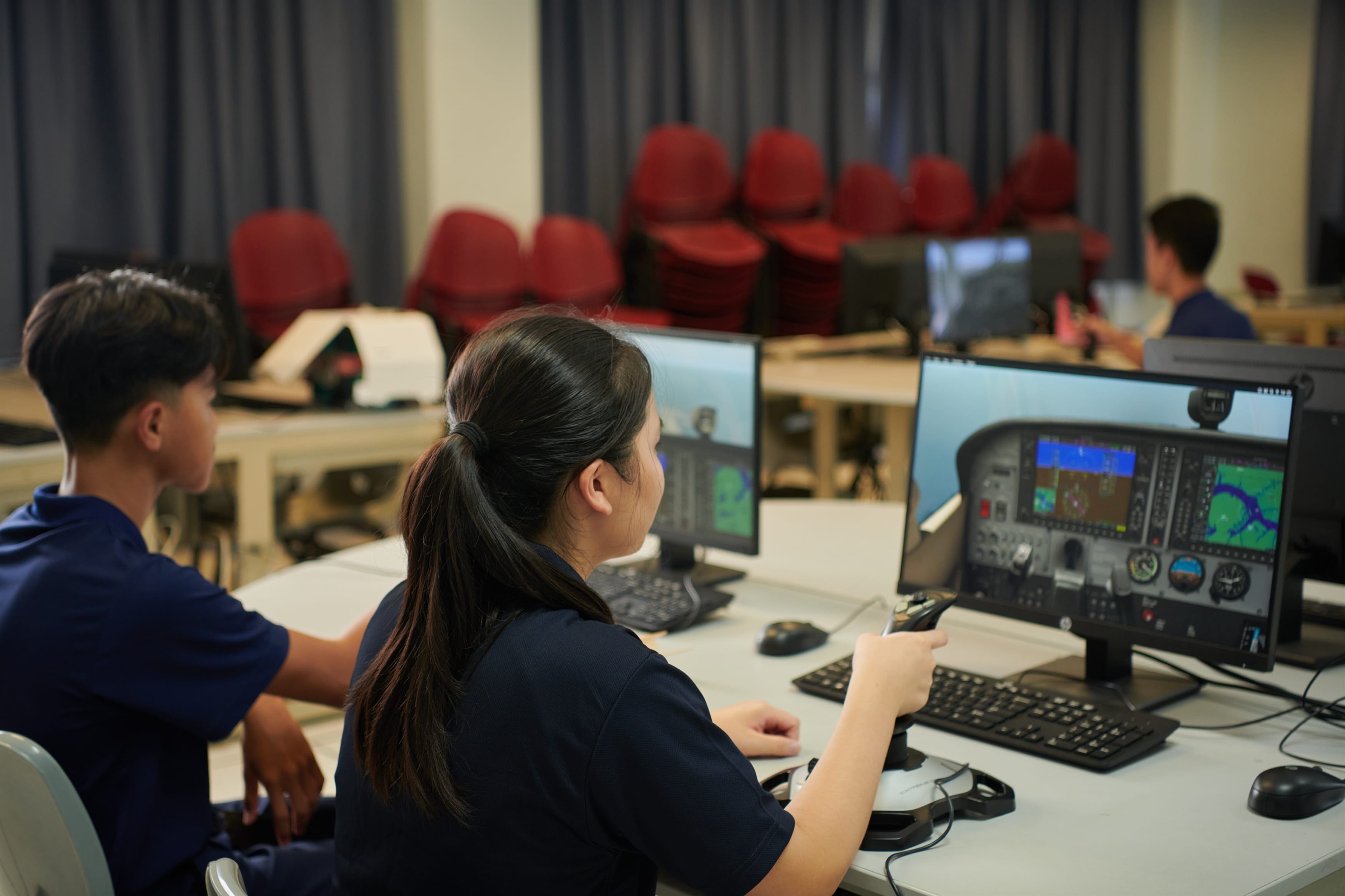 Students using a flight simulator in the lab.
